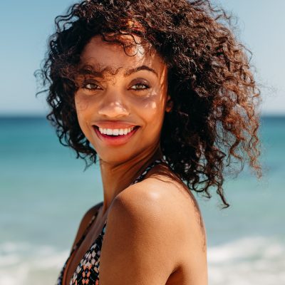 Portrait of a curly haired woman at the beach