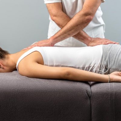 chiropractor-working-on-woman-s-back