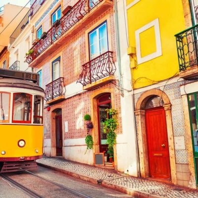 Yellow-tram-and-colorful-buildings-in-Lisbon-Portugal