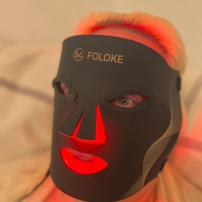 Side view of LED light therapy face mask showing fit and design on face.