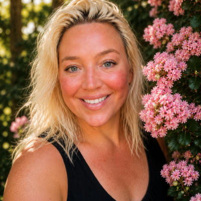 Andi Perullo photographed among pink flowers for her VoyageMIA interview feature.
