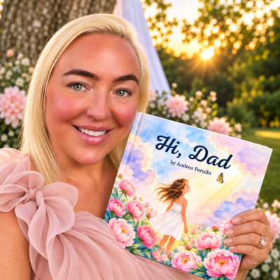 Author Andrea Perullo holding Hi, Dad, her children's book about grief, love, loss, and finding signs of someone you miss.